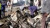 Somalian police examine the wreckage of the car after car bomb exploded in Mogadishu, Somalia, April 17, 2019.