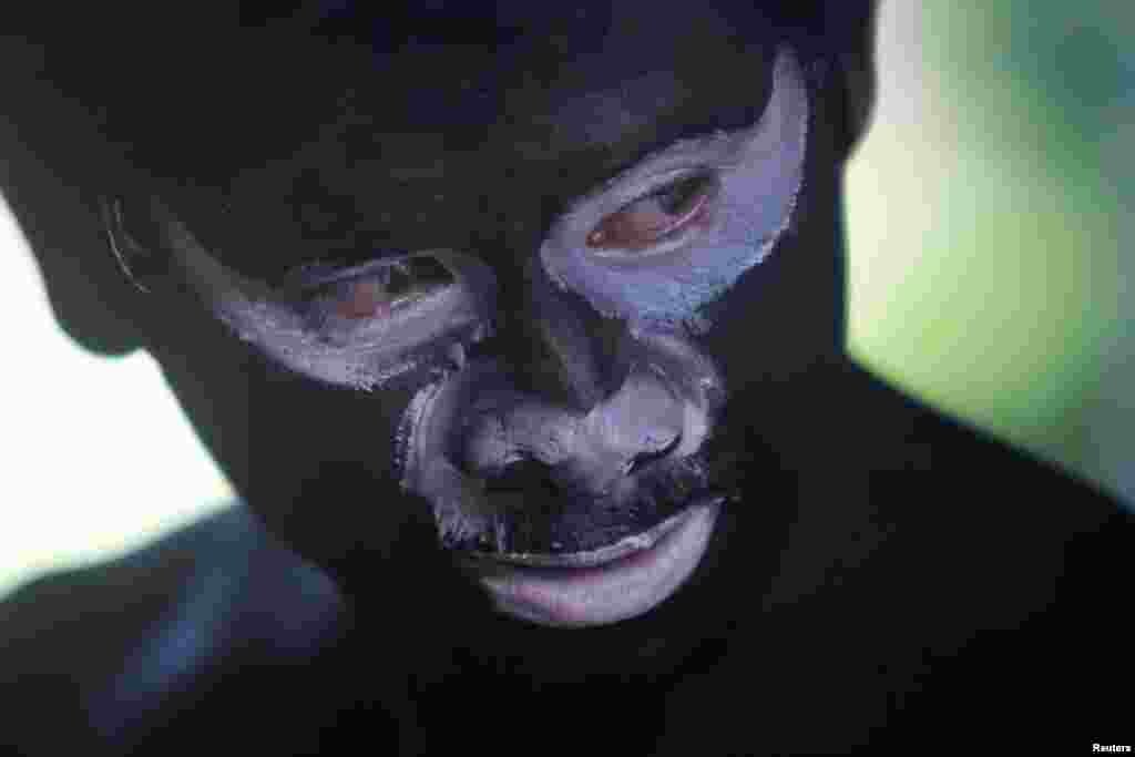 A man painted in black takes part in the annual &quot;Lok Ta Pring Ka-Ek&quot; religious festival, to pray for fortune and rain for the rice fields at the outskirts of Phnom Penh, Cambodia.