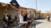 A resident of Tabqa city touring the streets on a motorcycle waves an Islamist flag in celebration after Islamic State militants took over Tabqa air base, in nearby Raqqa city, Aug. 24, 2014.