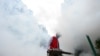 A volunteer disinfects a residential compound to prevent and control the novel coronavirus, in Ganzhou, Jiangxi province, China February 6, 2020. 