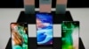 The new Samsung S10 phones are displayed Feb. 20, 2019, in San Francisco. Samsung is hailing the 10th anniversary of its first smartphone with three new models that it hopes reverses a sales slump in an industry recycling the same ideas.