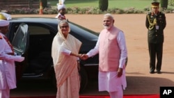 Indian Prime Minister Narendra Modi shakes hand with his Bangladeshi counterpart Sheikh Hasina at the Presidential Palace in New Delhi, India, Saturday, April 8, 2017. 