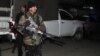 A policeman stands near the site of a rocket attack at Peshawar's airport in Pakistan, Dec. 15, 2012. 