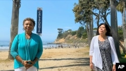 In this image from video, Rep. Barbara Lee, D-Calif., left, and rep. Hilda Solis, D-Calif., speak during the state roll call vote on second night of the Democratic National Convention Aug. 18, 2020.