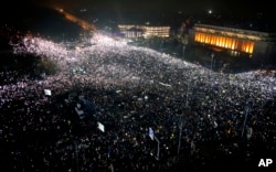 FILE - Tens of thousands of people gather for a demonstration in from of the government building in Bucharest, Romania, Feb. 5, 2017.