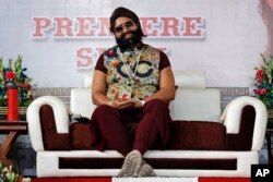 FILE - In this May 17, 2017 file photo, an Indian spiritual guru, who calls himself Saint Dr. Gurmeet Ram Rahim Singh Ji Insan, attends the premiere of the movie 'Jattu Engineer' in New Delhi, India.