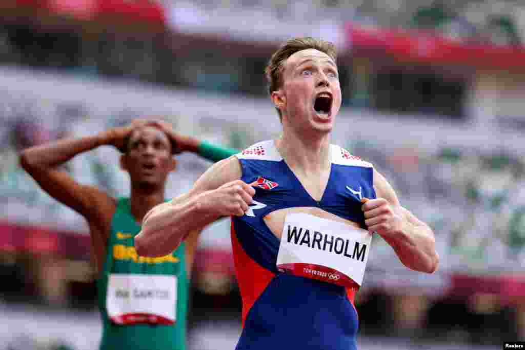 Karsten Warholm of Norway celebrates as he wins the gold medal in the final of the men&#39;s 400-meter hurdles at the 2020 Summer Olympics in Tokyo, Japan.