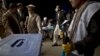 Afghan election workers prepare ballot boxes and election materials to be loaded into trucks and delivered to polling stations, at a warehouse in Kabul, Afghanistan, April 3, 2014.