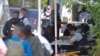 FILE - Refugees are processed by the Royal Canadian Mounted Police (RCMP) after crossing illegally into Canada at the U.S.-Canada border on Roxham Road from Champlain, New York, August 3, 2017. 