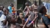 In this photo taken Sunday, Nov. 9, 2014, a dozen children perform a traditional courtship dance from eastern Uganda as part of a platform for changing attitudes among youth using dance, drama and popular hip hop music, at the Treasure Life Center in the Kamwokya slum of Kampala, Uganda. As World AIDS Day is marked on Dec. 1, Uganda and many other African countries are continuing their battle against HIV and AIDS, and Ugandan street activists like 26-year-old Hood Katende are trying to use music and drama to stem a troubling resurgence of HIV, which now infects more than 500 young women between the ages of 15 and 24 each week, according to the Uganda AIDS Commission. (AP Photo/Rebecca Vassie)