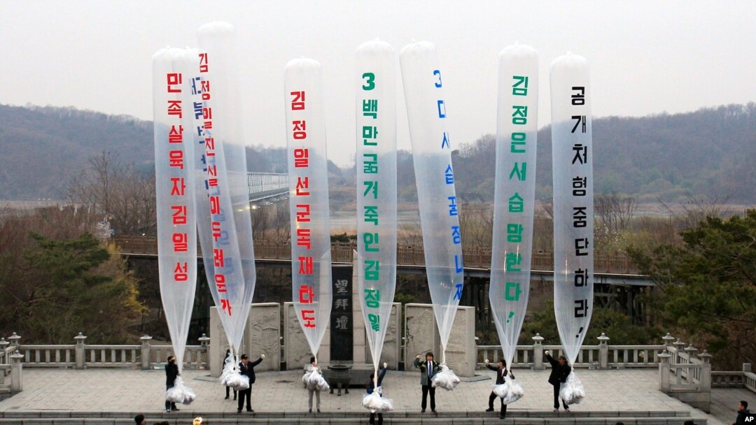 FILE - In this April 15, 2011 file photo, Park Sang Hak, center, a refugee from the North who now runs the group Fighters for a Free North Korea from a small Seoul office, and South Korean conservative activists prepare to release balloons bearing…