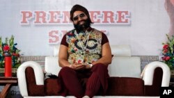  FILE - In this May 17, 2017 file photo, an Indian spiritual guru, who calls himself Saint Dr. Gurmeet Ram Rahim Singh Ji Insan, attends the premiere of the movie 'Jattu Engineer' in New Delhi, India. 