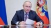 In this picture made available by Sputnik news agency, Russian President Vladimir Putin chairs a meeting with members of the government via a video conference at the Novo-Ogaryovo state residence outside Moscow, on Dec. 24, 2021. (Alexey Nikolsky/ Sputnik