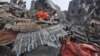 Investigators inspect the wreckage of the crashed air force transport plane in Medan, North Sumatra, Indonesia, Wednesday, July 1, 2015.