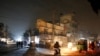 Vehicles headlights light a dark street during widespread power outages in Rawalpindi, Pakistan, Jan. 10, 2021. 