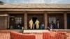FILE - Medical workers lead a young girl with suspected Ebola into the unconfirmed Ebola patients ward run by The Alliance for International Medical Action (ALIMA), Aug. 12, 2018 in Beni, northeastern DRC.