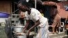 A woman prepares soup to sell on a street in Lagos, Nigeria, Aug. 7, 2014. 