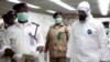 Nigerian health officials wait to screen passengers at the arrivals hall of Murtala Muhammed International Airport in Lagos, Nigeria, Aug. 4, 2014.