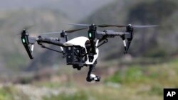FILE - The Inspire 1, a drone manufactured by DJI, is flown in Davenport, Calif., March 10, 2015. 