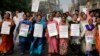 Activists of Trinamool Congress party hold banners and shout slogan during a protest march against the government's decision to withdraw high denomination notes from circulation, in Kolkata, India, Nov. 28, 2016. 
