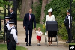 Britain's Prince William, Kate the Duchess of Cambridge, their son Prince George and daughter Princess Charlotte in a pram arrive for Charlotte's Christening at St. Mary Magdalene Church in Sandringham, England, July 5, 2015.