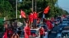 Supporters of the National League for Democracy (NLD) party celebrate with a cut-out figure of Myanmar state counsellor Aung San Suu Kyi in Yangon on November 10, 2020, as NLD officials said they were confident of a landslide victory in the weekend…