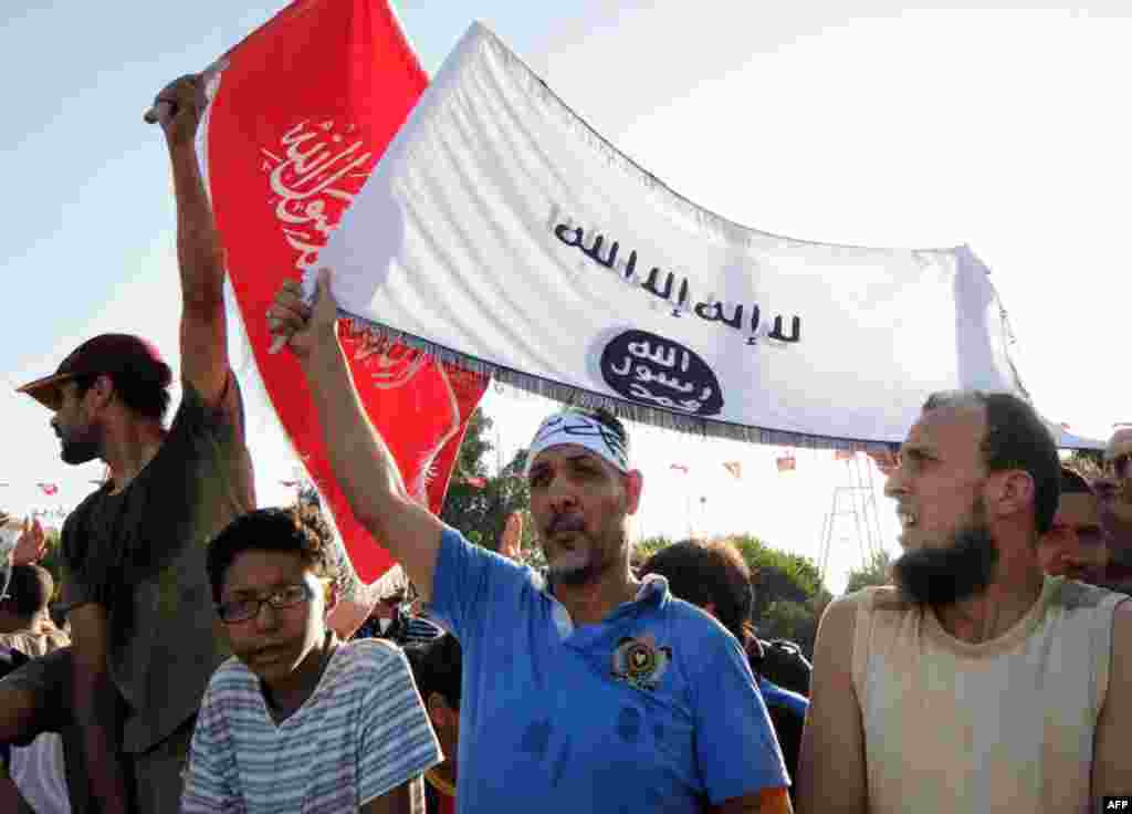 Supporters of the ruling Ennahda party chant slogans outside the headquarters of the Constituent Assembly in solidarity with the Islamist government, Tunis, July 28, 2013.