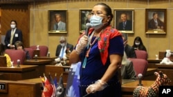 Democratic state Sen. Jamescita Peshlakai wears a mask as she tells member how the coronavirus has devastated the Navajo Nation while urging members to approve a move to end the legislative session at the state Capitol in Phoenix, May 8, 2020.
