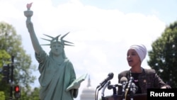 FILE - Representative Ilhan Omar addresses a small rally on immigration rights at the temporary installation of a replica of the Statue of Liberty at Union Station in Washington, May 16, 2019.