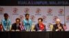 Thai Prime Minister Prayuth Chan-ocha, left, and Vietnam's Prime Minister Nguyen Tan Dung, center, sign documents as Malaysia's Prime Minister Najib Razak looks on during the signing ceremony of the 2015 Kuala Lumpur Declaration on the Establishment of the ASEAN Community and the Kuala Lumpur Declaration on ASEAN 2025, in Kuala Lumpur, Malaysia, Nov. 22, 2015.