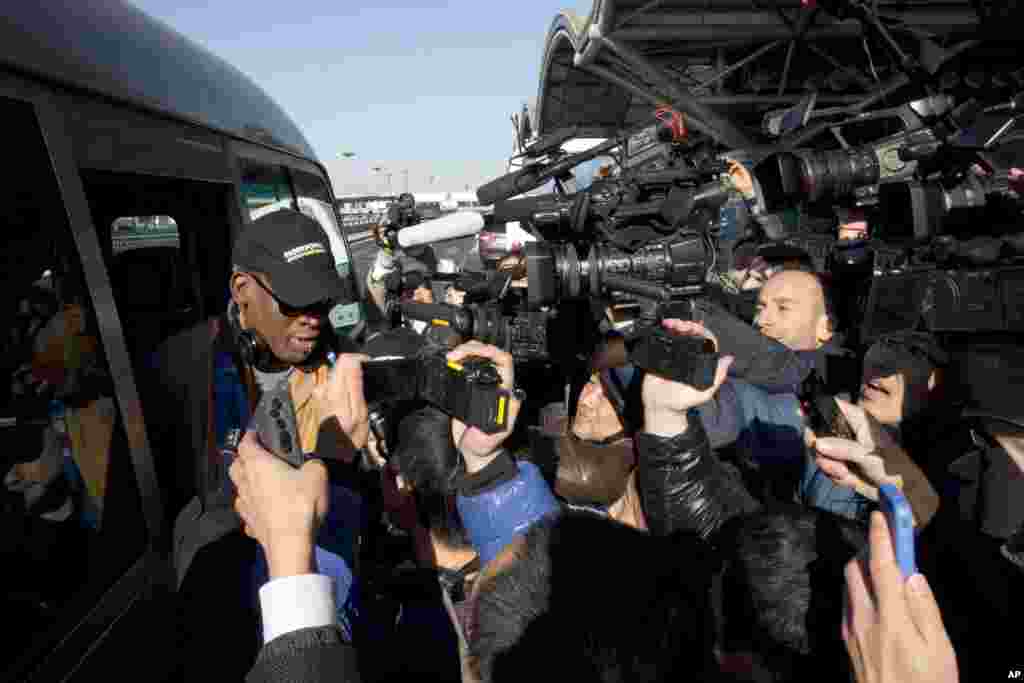 Dennis Rodman arrives at the capital airport in Beijing, on his way to North Korea, Dec. 19, 2013. 