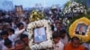 Thousands of mourners gather at the gates of the Royal Palace minutes after the coffin of former king Norodom Sihanouk arrived in Phnom Penh October 17, 2012. Tens of thousands poured into Cambodia's capital to witness the procession on Wednesday of the b