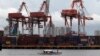 FILE - A small boat moves past one of the country's busiest ports at a portion of Manila Bay.
