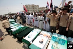 FILE - Yemenis attend the funeral of victims of a Saudi-led airstrike, in Saada, Yemen, Aug. 13, 2018.