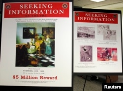 FILE - Posters displaying stolen works by artists Johannes Vermeer and Edgar Degas from the Isabella Stewart Gardner Museum in Boston, Massachusetts March March 18, 2013. The FBI is offering a 5 million dollar reward for the return of the paintings. (REUTERS/Jessica Rinaldi/File)
