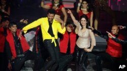 FILE - This July 6, 2013 file photo shows Bollywood actors Sridevi and Prabhu Deva, left in yellow, performing during the International Indian Film Academy (IIFA) awards in Macau.