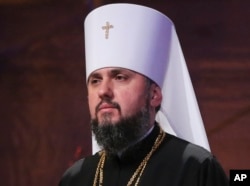 A new head of an independent Ukrainian church, Metropolitan of Kyiv Epiphanius, greets people gathered to support a new, independent Ukrainian church near the St. Sophia Cathedral in Kyiv, Ukraine, Dec. 15, 2018.