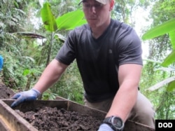 U.S. Marine Sgt. Brandon Rose assigned to Defense POW/MIA Accounting Agency (DPAA), screens soil from a test unit as part of a DPAA investigation mission near Bhismaknagar Village, Arunachal Pradesh, India, Dec. 02, 2016.