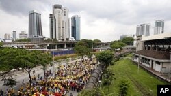 Protesters march on a street during a rally to demand for electoral reforms in Kuala Lumpur, Malaysia, April 28, 2012. 