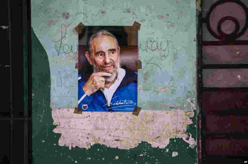 FILE - A poster of Cuban Revolution leader Fidel Castro hangs on a wall in Havana, Cuba, Aug. 13, 2016.