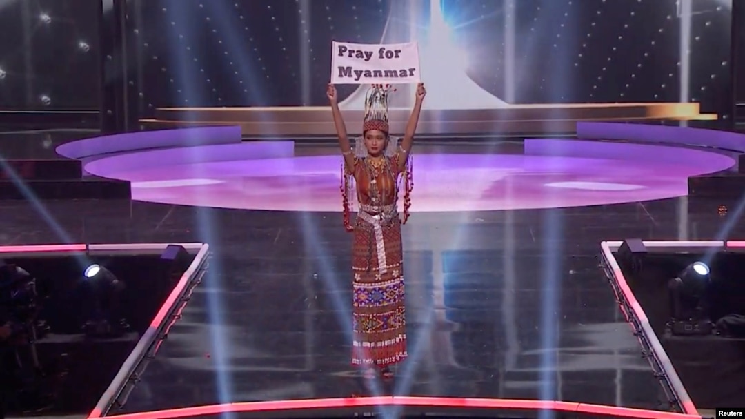 Ma Thuzar Wint Lwin, Miss Universe Myanmar, holds up the "Pray for Myanmar" sign during Miss Universe pageant's national costume show, in Hollywood, Florida, U.S., May 13, 2021 in this screengrab taken from a handout video. Courtesy MISS UNIVERSE/Handou