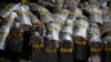Para aparat kepolisian tampak melindungi diri mereka dengan tameng ketika melakukan pengamanan dalam aksi unjuk rasa penentangan terhadap Undang-undang Omnibus di Jakarta, pada 13 Oktober 2020. (Foto: Reuters/Willy Kurniawan)