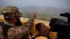 A Pakistan army officer points out the Indian forward area posts to journalists at Bagsar post on the Line of Control that divides Kashmir between Pakistan and India, on October 1, 2016. According to a report, Prime Minister Nawaz Sharif urged spy chief Rizwan Akhtar to take action in the region against three militant groups dedicated to fighting Indian forces. 