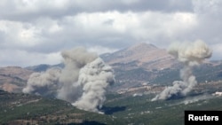 Smoke rises from Jabal al-Rihan as pictured from Marjayoun