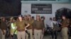Local police stand outside a house where a suspected militant is said to be hiding in Thakurganj area in Lucknow, India, March 7, 2017. 