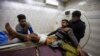 Kashmiris carry a boy who was injured in a grenade blast for treatment at a hospital in Srinagar, Indian-controlled Kashmir, Dec. 9, 2020. Four civilians were injured in the attack, which police blamed on rebels fighting against Indian rule.