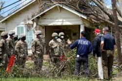 President Donald Trump and Homeland Security Secretary Chad Wolf speak with National Guard soldiers helping with cleanup as they tour damage from Hurricane Laura, Aug. 29, 2020, in Lake Charles, La.