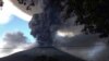 The Chaparrastique volcano, behind electricity cables, spews ash at the municipality of San Miguel December 29, 2013. The Chaparrastique volcano in eastern El Salvador belched a column of hot ash high into the air on Sunday, frightening nearby residents a