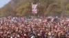 Supporters hold up a portrait of Zimbabwe Prime Minister Morgan Tsvangirai at his last campaign rally before elections set for Wednesday, in Harare, July, 29, 2013. 