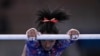 Simone Biles, of United States performs on the uneven bars during the women's artistic gymnastic qualifications at the 2020 Summer Olympics, July 25, 2021, in Tokyo. 